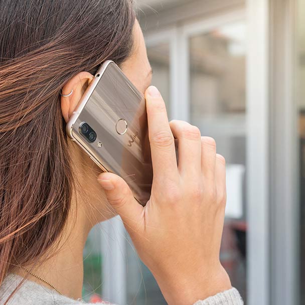 Woman calling someone with a wiko smartphone